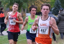  Harper Wesley runs in front of two other runners at cross country meet